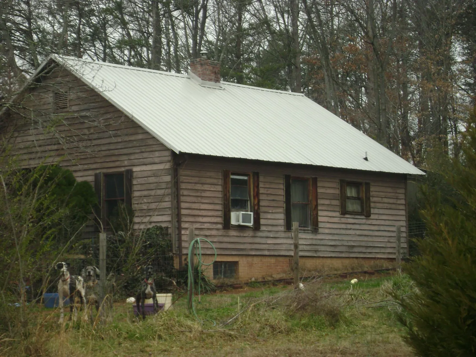 White metal roof on an old wood sided farmhouse, from a Metal Roof Installation job in Ligonier